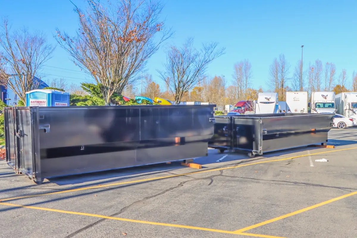 Professional dumpster rental service with roll-off container on residential driveway in Pinole